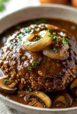 Delicious homemade Salisbury steak served with gravy and mashed potatoes