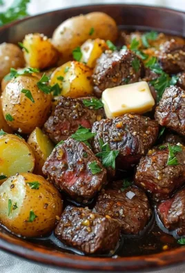 Slow cooker garlic butter steak bites served with potatoes