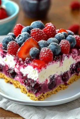 Delicious Summer Berry Jello Lasagna dessert with layers of berries and jello.