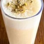 A refreshing Banana Chamomile Tea Smoothie with banana and chamomile flowers.