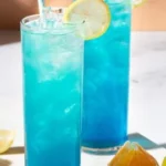 Refreshing Blue Mocktail served in a glass with garnishes