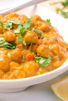 Delicious coconut curry chickpeas dish garnished with fresh herbs
