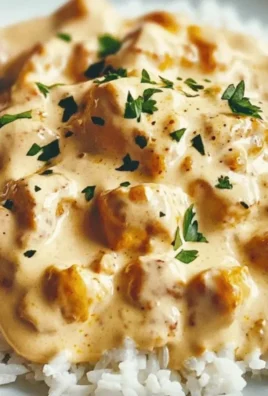 Delicious creamy smothered chicken served over rice