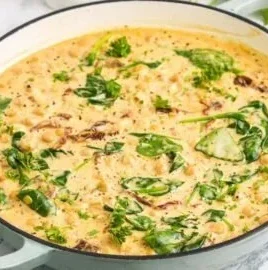 Creamy Tuscan Marry Me Chickpeas dish served in a bowl with herbs