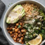 Crispy quinoa chickpea bowl with roasted broccoli and Meyer lemon tahini sauce