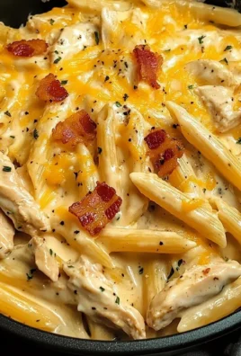 Creamy crack chicken penne dish with herbs and toppings