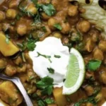 Delicious Garam Masala Curry served with rice and garnished with fresh herbs