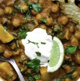 Delicious Garam Masala Curry served with rice and garnished with fresh herbs