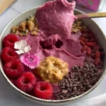 Delicious Glowy Skin Smoothie Bowl topped with fresh fruits and seeds