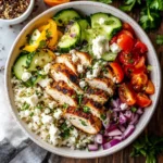 Delicious Greek Chicken Bowl with fresh vegetables and tzatziki sauce