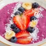 High protein berry smoothie bowl topped with fresh berries and nuts