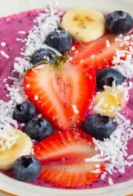 High protein berry smoothie bowl topped with fresh berries and nuts