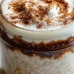 High protein cinnamon roll overnight oats served in a bowl with toppings.