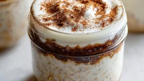 High protein cinnamon roll overnight oats served in a bowl with toppings.