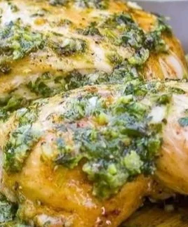 Plate of Lemon Herb Chicken garnished with herbs and lemon slices