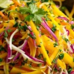 Colorful Mango Slaw salad with fresh ingredients and vibrant dressing