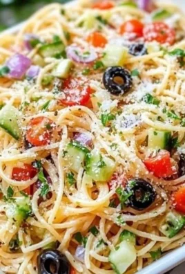 Bowl of spaghetti salad with colorful vegetables and Italian dressing