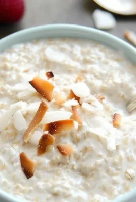 Bowl of tasty coconut cream oats topped with fruits and nuts.