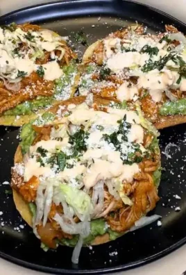 Delicious Chicken Tinga Tostadas topped with fresh ingredients and vibrant flavors.