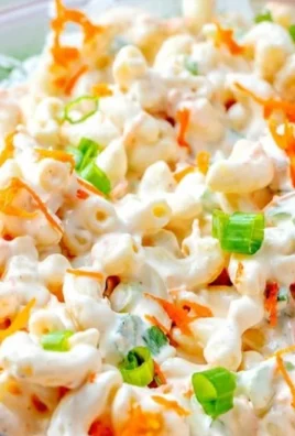 Bowl of classic Hawaiian macaroni salad with vegetables and dressing