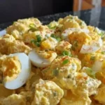 Bowl of classic potato salad with creamy dressing and fresh herbs