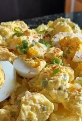 Bowl of classic potato salad with creamy dressing and fresh herbs