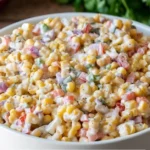 Delicious creamy corn salad with fresh ingredients ready to serve.