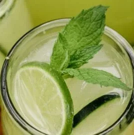 Refreshing Cucumber Lime Cooler beverage served in a glass with mint garnish