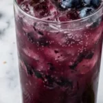 Coconut Blueberry Mint Mocktail garnished with mint leaves