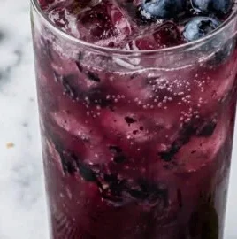 Coconut Blueberry Mint Mocktail garnished with mint leaves