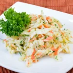 Bowl of easy vinegar coleslaw with colorful shredded vegetables