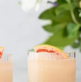 Frozen Paloma cocktail served with a lime wedge and salt rim.