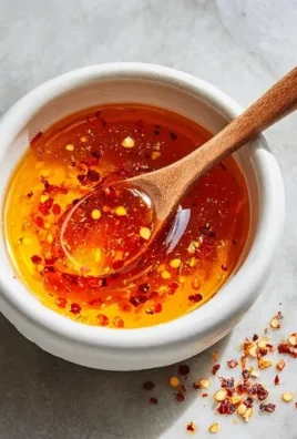 Bottle of Garlic Hot Honey showcasing its vibrant color and label