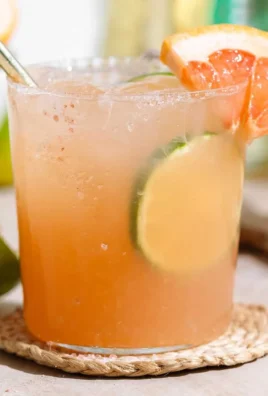 Refreshing Grapefruit Paloma cocktail garnished with fresh grapefruit.