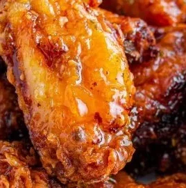 Delicious hot honey peach wings garnished and ready to serve