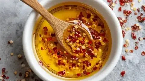 Bowl of homemade hot honey with chili flakes for an easy recipe