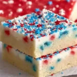 Delicious patriotic sugar cookie bars topped with red, white, and blue sprinkles.
