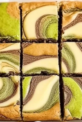 Pistachio Cheesecake Blondies topped with crushed pistachios and creamy cheesecake swirl