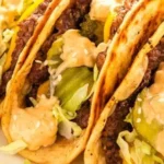 Smash burger tacos with fresh toppings and a crispy shell.