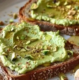 Delicious homemade pistachio cream spread in a jar with nuts.