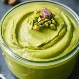 Homemade velvety pistachio cream in a glass jar