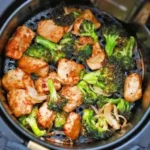 Air fryer chicken and broccoli on a plate, perfect for a healthy meal.