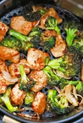 Air fryer chicken and broccoli on a plate, perfect for a healthy meal.