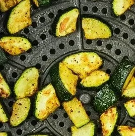 Crispy air fryer zucchini slices served on a plate