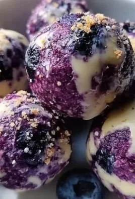 Blueberry cheesecake bites on a decorative plate with fresh blueberries