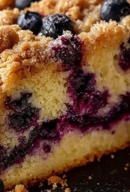 Freshly baked Blueberry Coffee Cake topped with blueberries and a crumbly crust