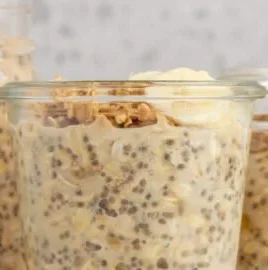 A bowl of brown sugar overnight oats topped with fresh fruit and nuts.