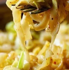 Plate of Cabbage and Noodles served with herbs and spices