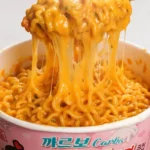 Delicious Carbonara Buldak Ramen bowl topped with cheese and green onions