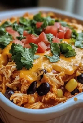 Delicious chicken taco casserole topped with cheese and fresh ingredients